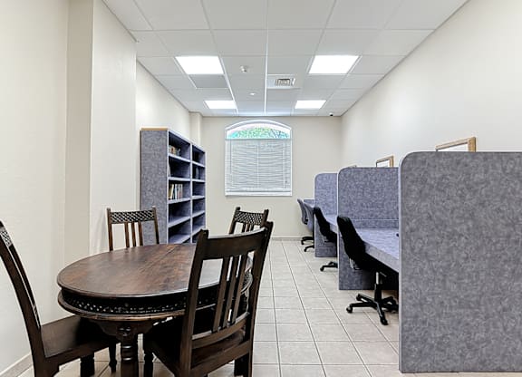 A business center with a table and chairs.