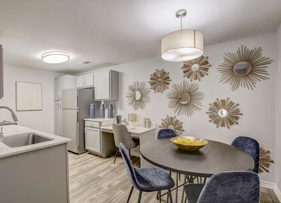 A modern kitchen with a dining table set for four.