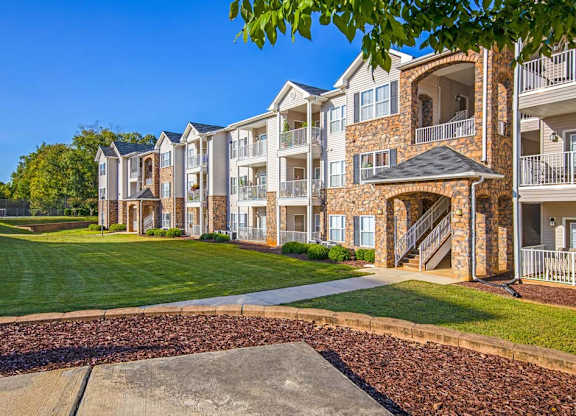 Apartment complex with a walkway in front at Ethan Pointe Apartments, Greensboro