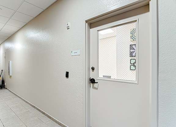 A white door with a glass window and a handle.