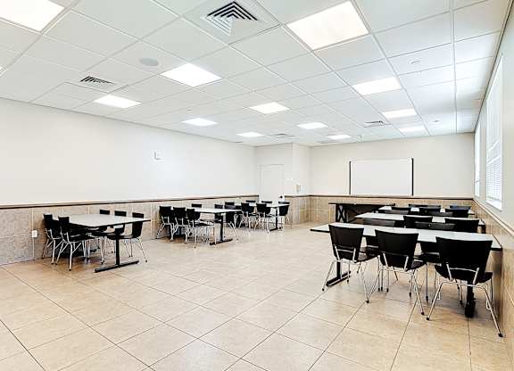 A conference room with tables and chairs.