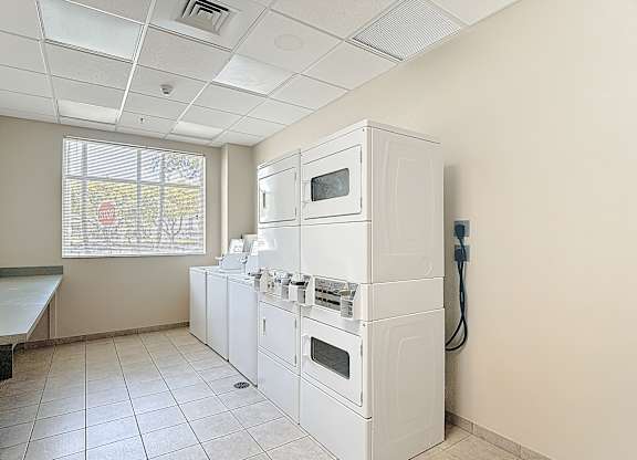 A white kitchen with a microwave, oven, and stove.
