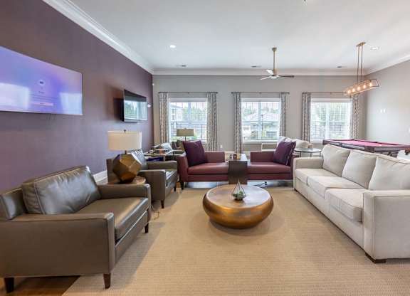 A living room with a white couch and a wooden coffee table at Foxwood Apartments, North Carolina