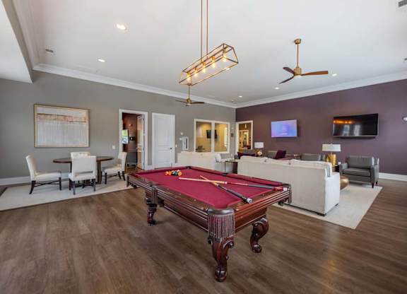 A room with a pool table and a television at Foxwood Apartments, Raleigh-Durham