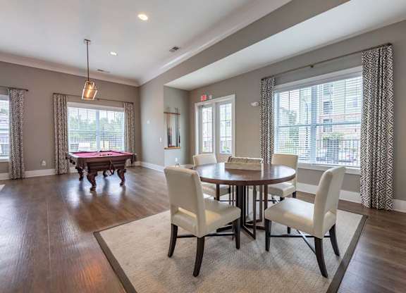 A dining room with a table set for four at Foxwood Apartments, North Carolina, 27616
