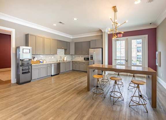 A kitchen with a bar stool and a bar table at Foxwood Apartments, Raleigh-Durham, North Carolina