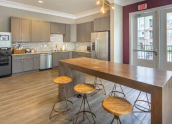 A kitchen with a bar area and a wooden counter at Foxwood Apartments, North Carolina, 27616