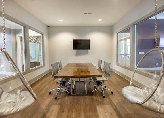 A conference room with a wooden table and chairs at Foxwood Apartments, Raleigh-Durham