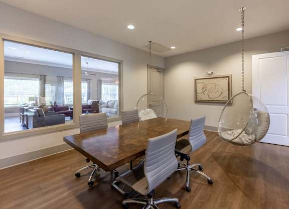 A conference room with a long table and chairs at Foxwood Apartments, North Carolina, 27616