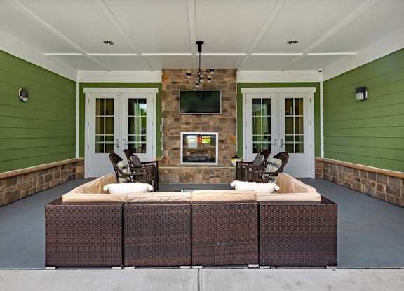 A patio with a fireplace and seating area at Foxwood Apartments, Raleigh-Durham