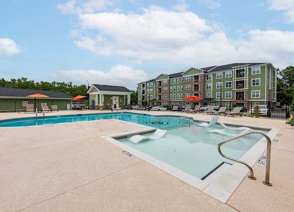 A large swimming pool with a slide in front of a building at Foxwood Apartments, Raleigh-Durham, North Carolina