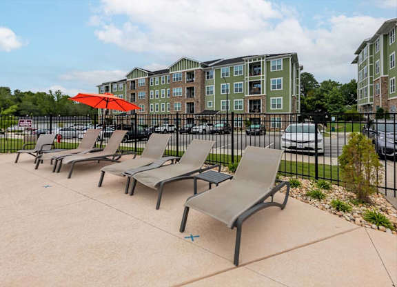 A row of grey chairs are lined up on a concrete area at Foxwood Apartments, Raleigh-Durham, NC, 27616