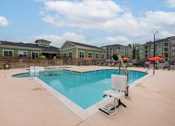 A swimming pool with a slide and a sun lounger at Foxwood Apartments, Raleigh-Durham, NC
