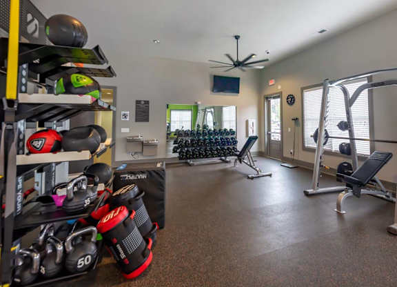 A well-equipped home gym with a variety of exercise equipment at Foxwood Apartments, North Carolina, 27616