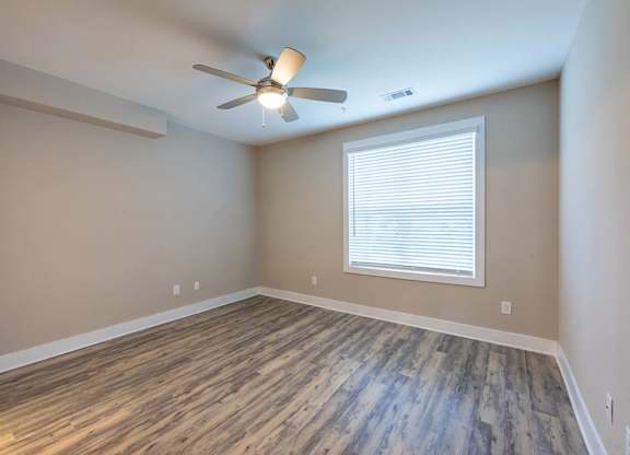 A room with a ceiling fan and a window with blinds at Foxwood Apartments, Raleigh-Durham, NC, 27616