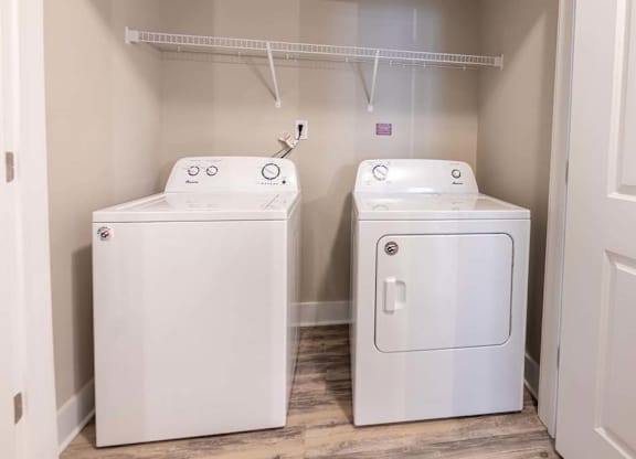 A small laundry room with a washer and dryer at Foxwood Apartments, North Carolina