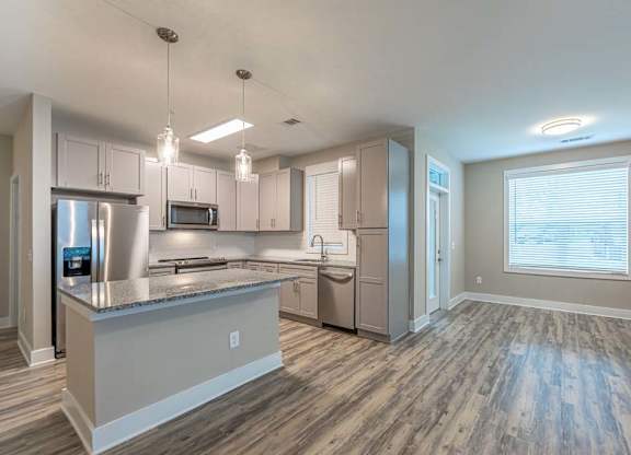A modern kitchen with a large island and stainless steel appliances at Foxwood Apartments, Raleigh-Durham, 27616