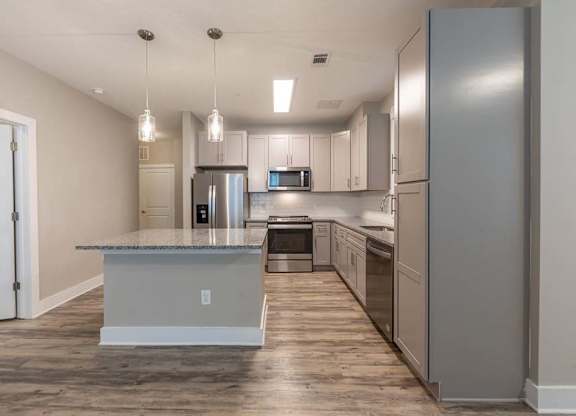A kitchen with a granite countertop and stainless steel appliances at Foxwood Apartments, Raleigh-Durham, North Carolina
