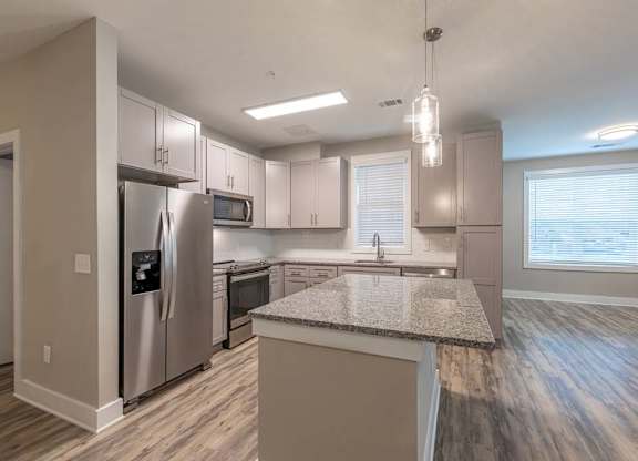 A kitchen with a granite countertop and stainless steel appliances at Foxwood Apartments, Raleigh-Durham