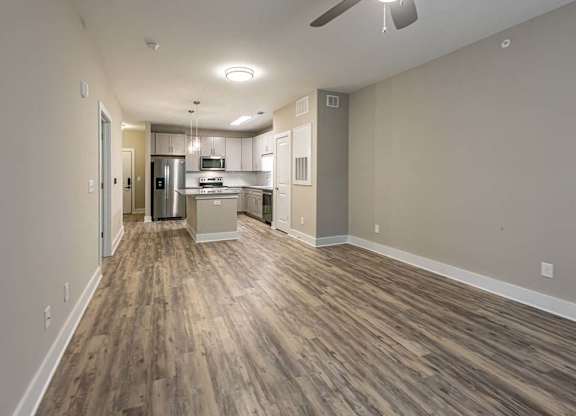 A kitchen area with a refrigerator, microwave, and oven at Foxwood Apartments, Raleigh-Durham, North Carolina
