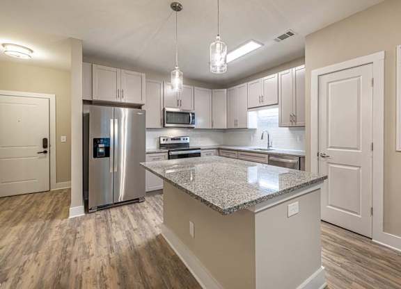 A kitchen with a granite countertop and stainless steel appliances at Foxwood Apartments, North Carolina, 27616