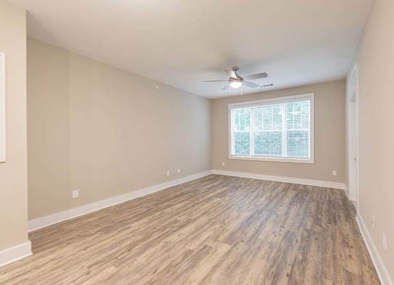 A room with wooden flooring and a ceiling fan at Foxwood Apartments, Raleigh-Durham, 27616