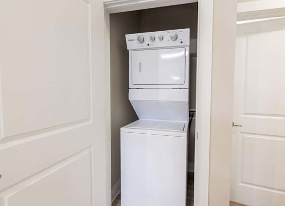 A white oven and stove top are in a small kitchen at Foxwood Apartments, Raleigh-Durham, NC