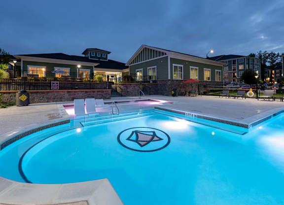 A pool with a diamond logo in the middle of it at Foxwood Apartments, Raleigh-Durham