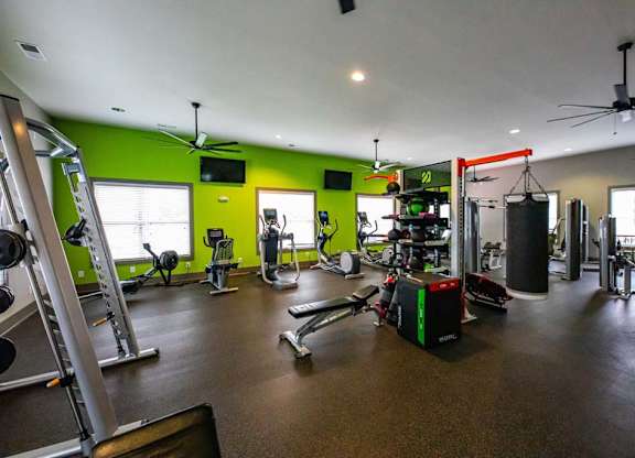 A gym with a variety of equipment including weights and cardio machines at Foxwood Apartments, North Carolina, 27616