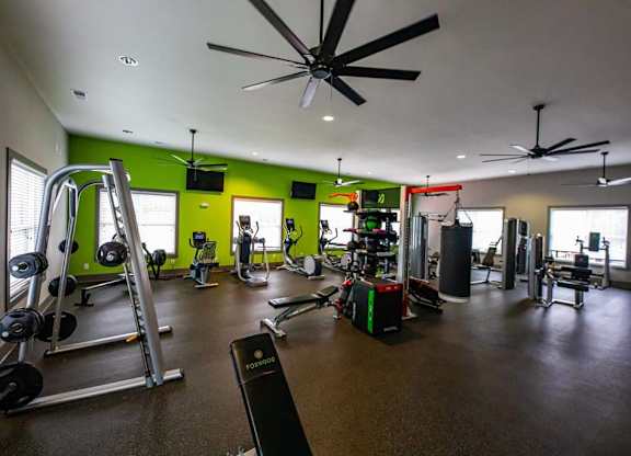 A gym with a variety of equipment including weights and cardio machines. at Foxwood Apartments, Raleigh-Durham, North Carolina