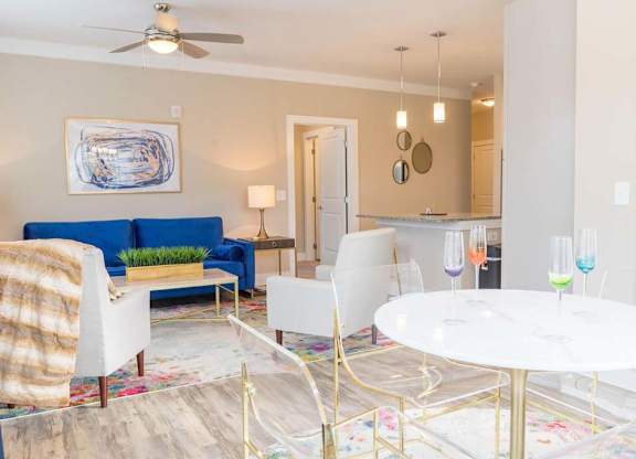 A living room with a blue couch and a white coffee table at Foxwood Apartments, Raleigh-Durham, North Carolina