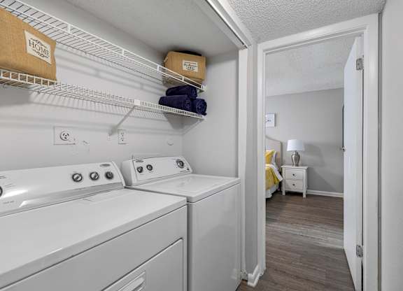 A small laundry room with a washer and dryer.