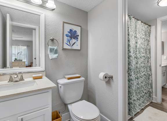 A white toilet sits next to a sink in a bathroom.