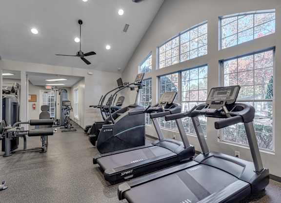 A gym with treadmills and other exercise equipment.