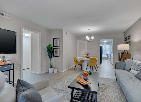 A living room with a grey couch and a yellow chair.