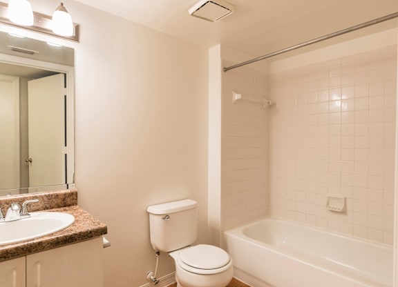 A white toilet sits next to a sink in a bathroom.