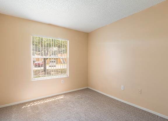 A room with a window and a view of the outside.