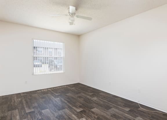 a bedroom with a bed and a ceiling fan