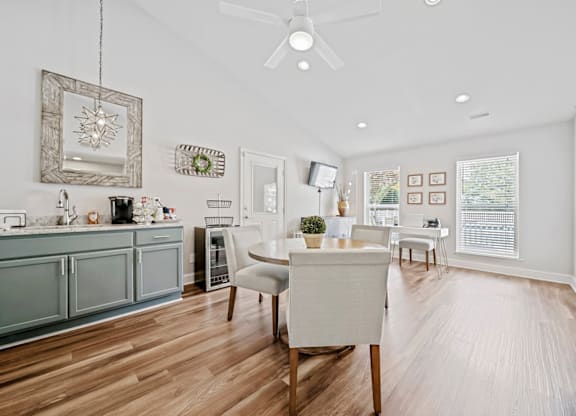 A modern kitchen with a dining table and chairs. at Brandemere Apartment Homes, Winston Salem