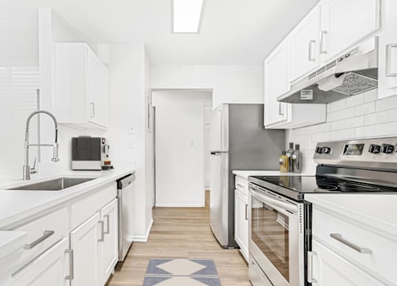 a kitchen with white cabinets and stainless steel appliances at Bridges at Mallard Creek Apartment Homes, Charlotte, NC, 28269
