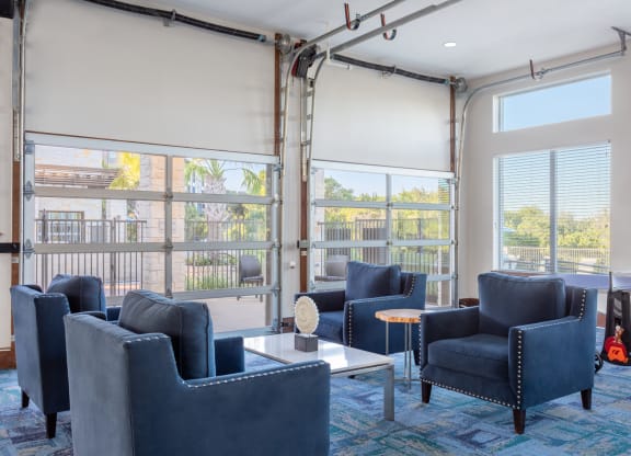 clubhouse with blue chairs and firehouse style garage doors