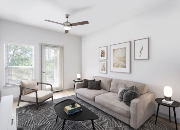 an image of a living room with a couch and windows