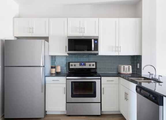 kitchen with stainless steel appliances and white cabinets