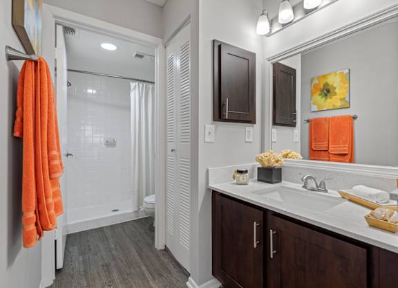 A bathroom with a white sink and a mirror.