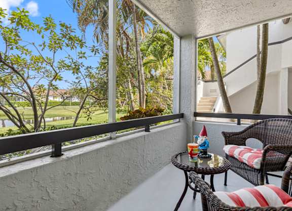 A balcony with a table and chairs