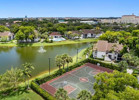 apartment community with a view of a lake and sports court