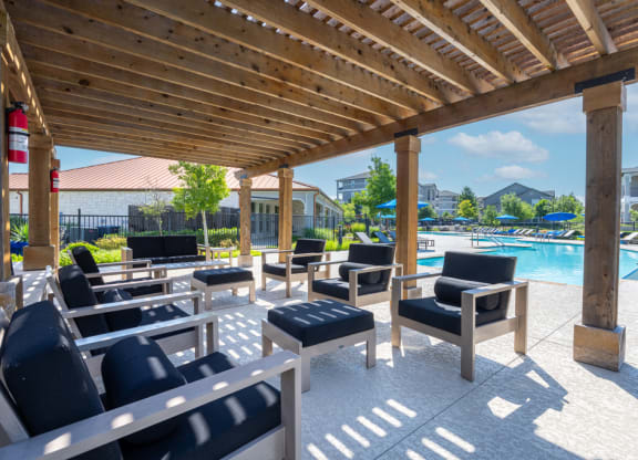 Outdoor covered seating area next to pool