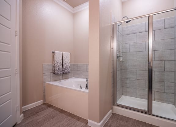 Bathroom facing soaking tub and stand up shower