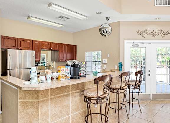 Interior or resident clubhouse facing kitchen and breakfast bar area