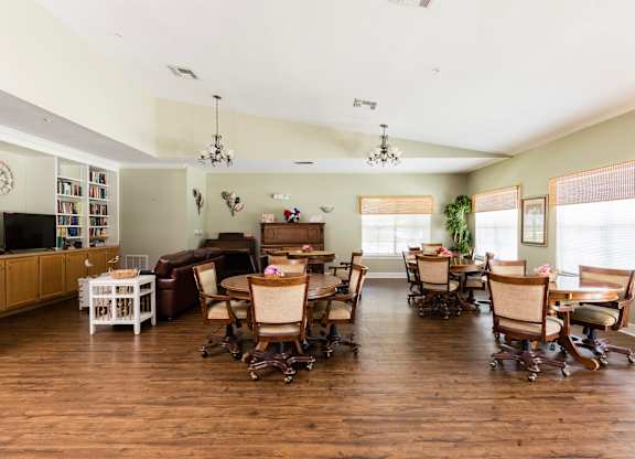 A living room with a dining table and chairs.